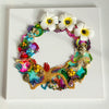 Abstract coral reef inspired wreath with colorful beads, embroidery, faux flowers, and gold thread on white canvas background