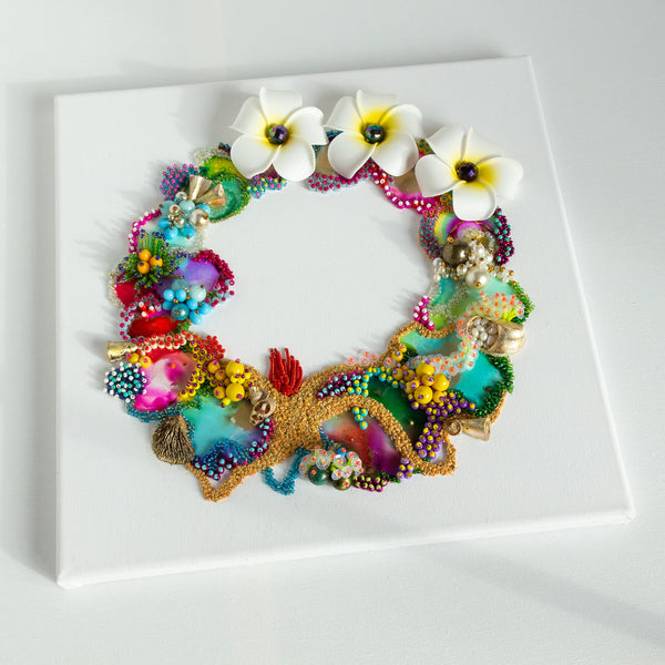 Abstract coral reef-inspired wreath artwork with plumeria flowers, beads, embroidery, and vibrant colors on square canvas.