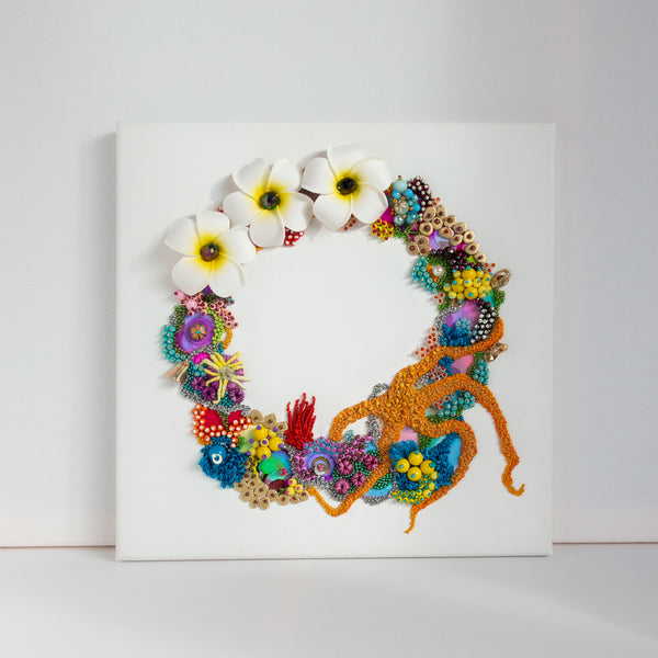 Abstract coral reef inspired wreath artwork with flowers, beads, embroidery, and mixed media on square canvas wall hanging.