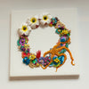 Abstract coral reef wreath art with beads, embroidery, faux flowers, and metallic thread on a 30cm square canvas.