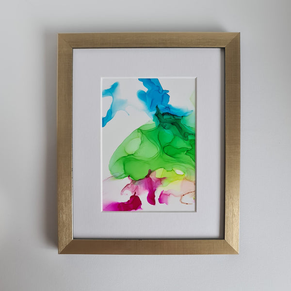 Abstract alcohol ink painting titled Dionysus 2018 with blue, green, and pink hues, mounted in white mat, gold frame not included