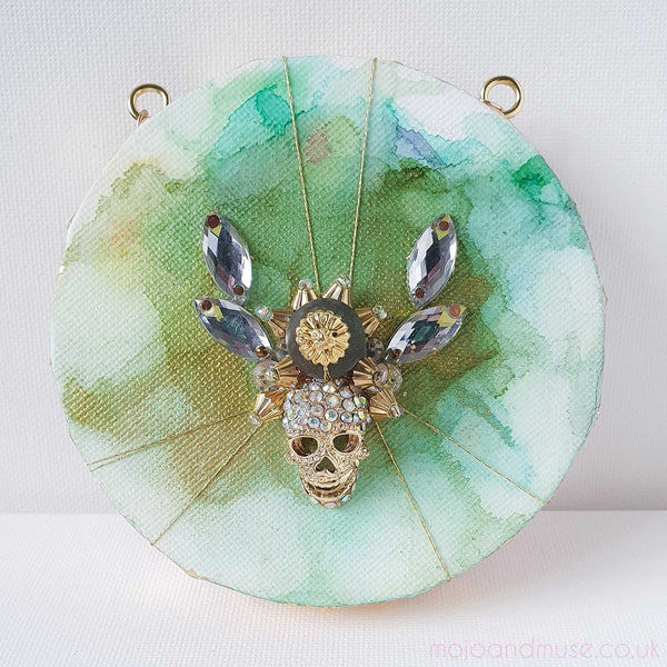 Features colorful embroidery on canvas, with intricate beadwork, gold threads, and vibrant yarns, inspired by the Day of the Dead celebrations.