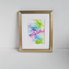 Abstract alcohol ink artwork titled Eostre 2018 with soft spring colors in gold frame on white wall background