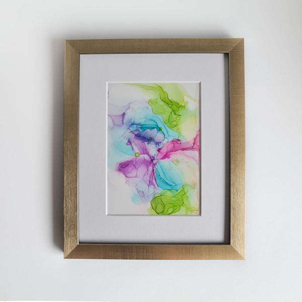 Abstract alcohol ink painting titled Eostre 2018 with vibrant spring colors, mounted in 10x8 white frame, gold frame not included.