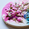 Close-up of intricate alcohol ink and hand-embroidered artwork with beads and gold thread on canvas circular panel.