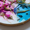 Close-up of Exquisite Structures Two 2022 showing detailed hand embroidery and beadwork on alcohol ink canvas with gold leaf edging