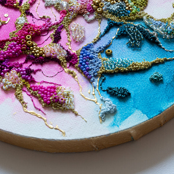 Close-up of Exquisite Structures Two 2022 showing detailed hand embroidery and beadwork on alcohol ink canvas with gold leaf edging