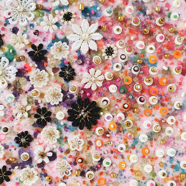 Close-up of Flora 1.0 artwork with embroidered lace flowers, beads, sequins, and colorful felt background.