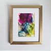 Abstract alcohol ink painting "Hera, 2018" with vibrant purple, blue, green, and yellow hues in a gold frame.