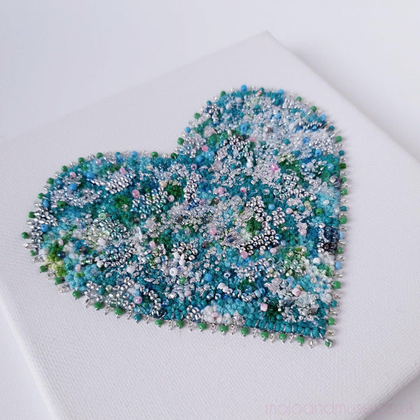 Close-up of Mint Heart 1.5 embroidery art with beads, gold leaf, and alcohol ink on canvas, 15cm square.