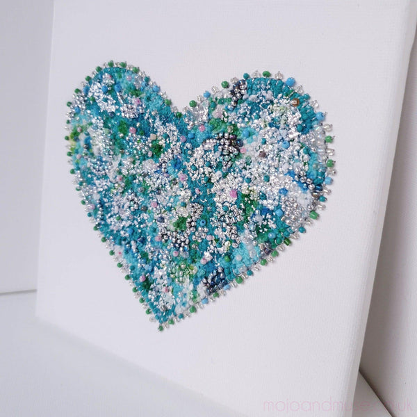 Mint heart artwork with embroidery thread, beads, gold leaf, and alcohol ink on white canvas, part of Heart Series.