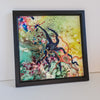 Square resin artwork featuring embroidered and beaded starfish and tide pool creatures in vibrant colors with wooden frame.