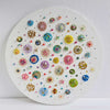 Circular canvas artwork with colorful embroidered beads, sequins, and gold leaf in intricate patterns titled Sea Jewels in the Snow.