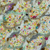 Close-up of intricate hand-embroidered canvas with beads, sequins, and colorful threads inspired by vibrant ocean sand.