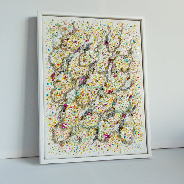 Hand-embroidered abstract artwork with colorful beads, threads, and confetti inspired by ocean sand, on canvas, unframed.