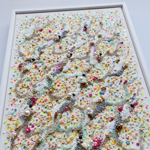 Hand-embroidered canvas artwork with colorful beads, sequins, and threads inspired by sparkling ocean sand, 40x30cm unframed.
