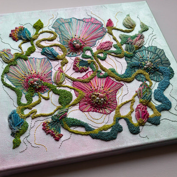 Abstract floral embroidery with metallic paint, seed beads, and gold thread on canvas, colorful textured art piece.