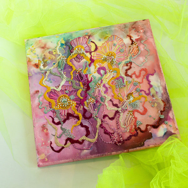 Abstract floral alcohol ink artwork with hand embroidery, seed beads, and metallic threads on canvas, 30.5cm square.