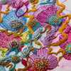 Close-up of colorful embroidered abstract floral design with beads and gold thread on canvas artwork