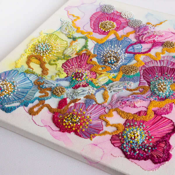 Close-up of Viola Three 2022 mixed media artwork featuring vibrant embroidered flowers on canvas with beads and gold thread.