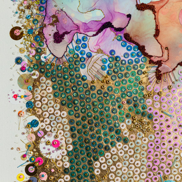 Close-up of colorful alcohol ink artwork with hand-embroidered beads, sequins, and gold threads on canvas.
