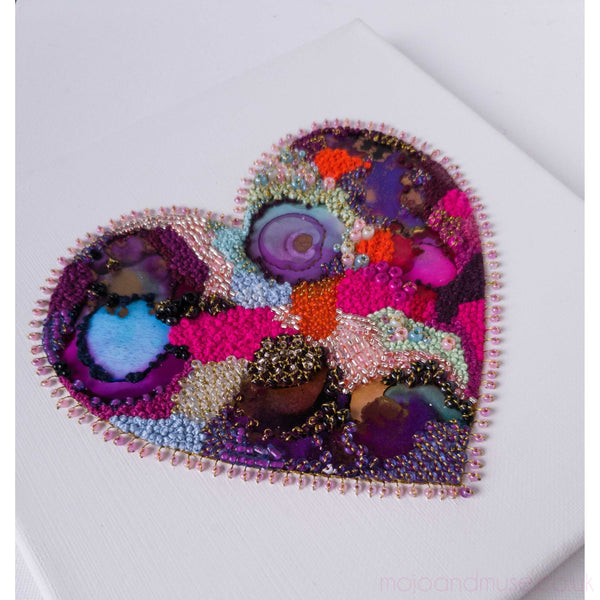 Handcrafted heart artwork with embroidery, metallic thread, beads, and alcohol ink on canvas, measuring 20cm square.